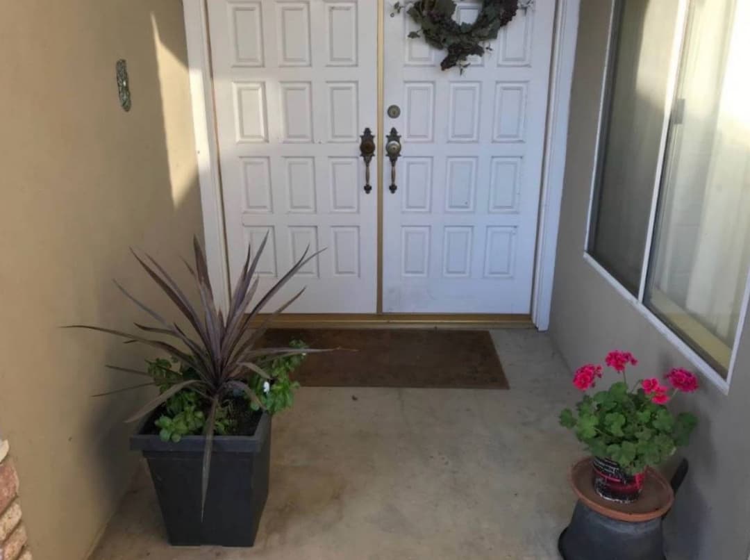 Professional cleaner scrubbing shower tiles during deep bathroom cleaning