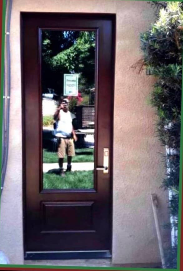 Decorative glass front door installation at residential entry