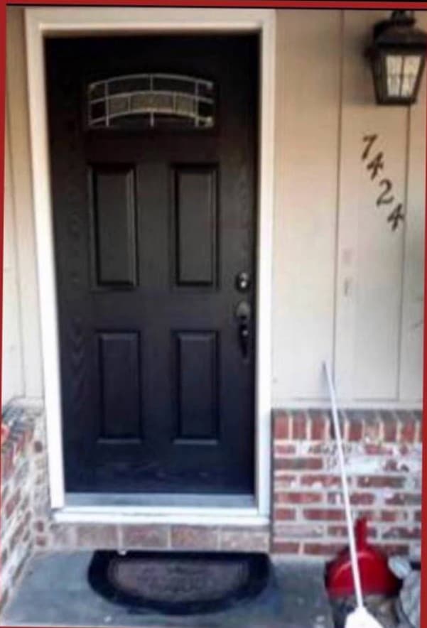 Black front entry door installation with modern hardware